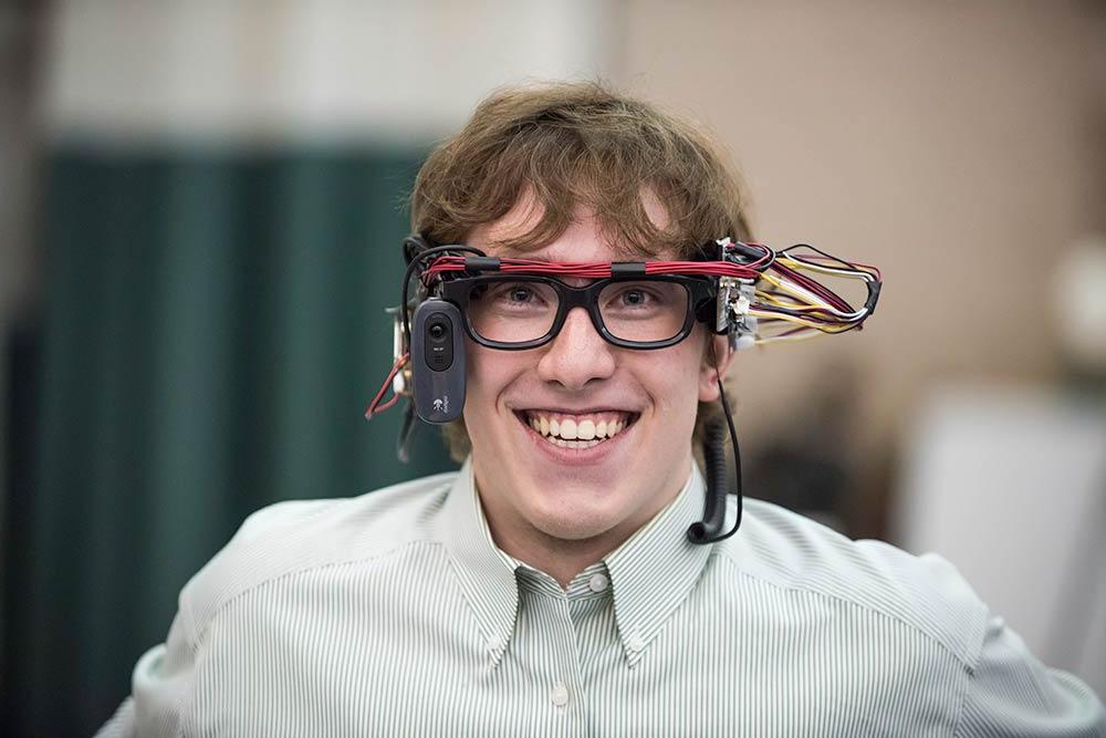 Student smiles while wearing VR goggles